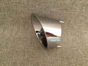 Shiny metal bowl on a textured beige surface.