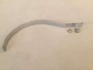 Curved metal bracket with bolts on fabric.