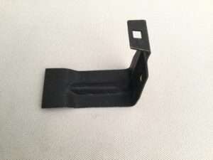 Black metal bracket on textured background.