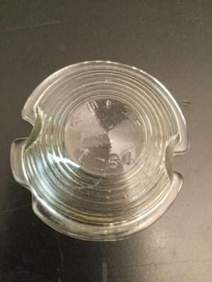 Clear glass ashtray on dark surface.