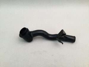 Black plastic automotive engine pipe on white background.