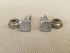 Metal bolts and nuts on fabric surface