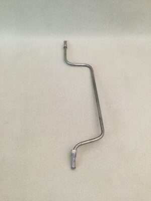 Metal crank handle on fabric background.