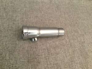 Stainless steel sink faucet spout on fabric background.