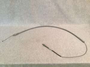 Flexible metal cable on fabric background.