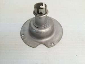 Metal lamp base on white surface.