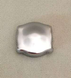 Silver object on textured background.