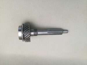 Metal gear shaft on gray background.