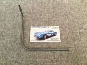Business card for Corvette collector beside a metal rod.