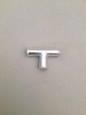 Silver metal T-joint pipe on textured background.