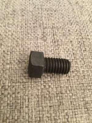 Black hex bolt on textured fabric.