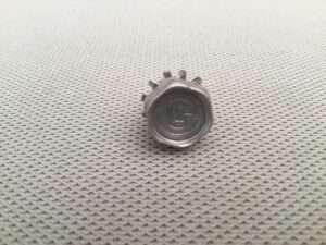 Plastic bottle cap on textured surface.