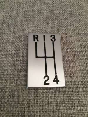 Manual gearshift pattern plate on fabric.