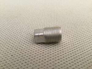 Metal bolt on textured surface.