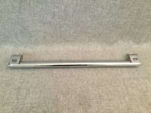 Metal towel rack on textured background.