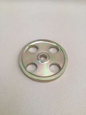 Metal flange with four holes on textured background.