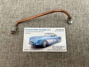 Copper pipe and business card with Corvette image.