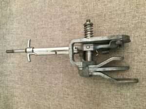 Metal carpenter's clamp on fabric background.