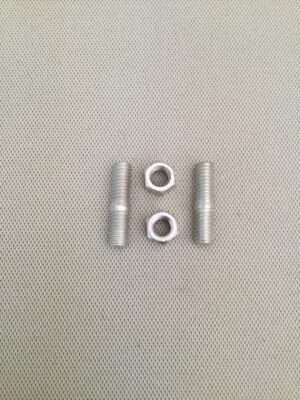 Three metallic bolts and two nuts on fabric.
