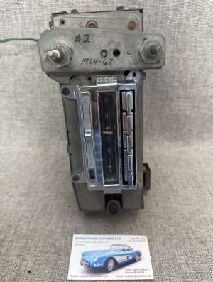 Vintage car odometer instrument on fabric background.