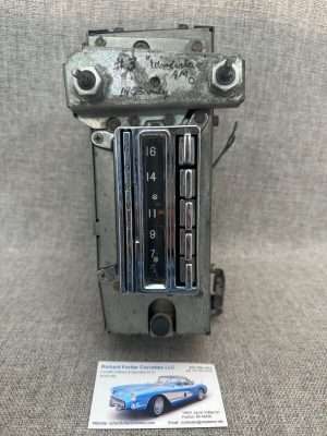 Vintage automobile radio on textured background.