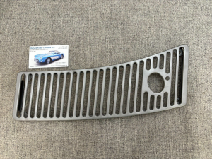 Car grille on fabric surface with business card.