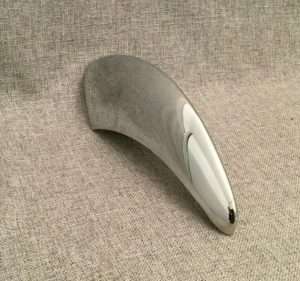 Ergonomic wireless mouse on textured gray background.